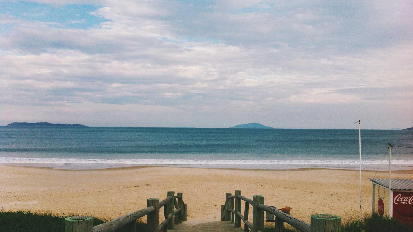 A timber boardwalk leading down to a beach