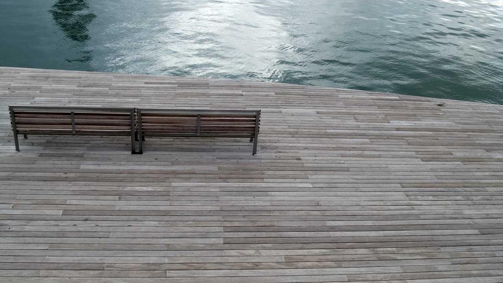 A weathered timber pier over calm water